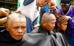 HAIR YESTERDAY, GONE TODAY. A tribal leader is flanked by two  lumad women as they have their heads shaved to dramatize their demand  for the revocation of the Free and Prior Informed Consent granted by the  National Commission on Indigenous Peoples to a rancher in Kibawe,  Bukidnon. The lumads staged the shaving of their heads in front of the  regional office of the NCIP in Cagayan de Oro City on July 13, 2010.  MindaNews photo by Bob Lagsa