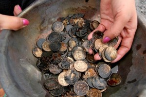 Ruby Cleopardas, 29, shows the coins she recovered from her burned piggy bank after fire struck their village in Barangay 31-D along Quezon Bouevard near Piapi in Davao City. The fire started at around 2:30 a.m. Saturday, 29 January. An estimated 300 houses were razed to the ground. Mindanews Photo by Keith Bacongco