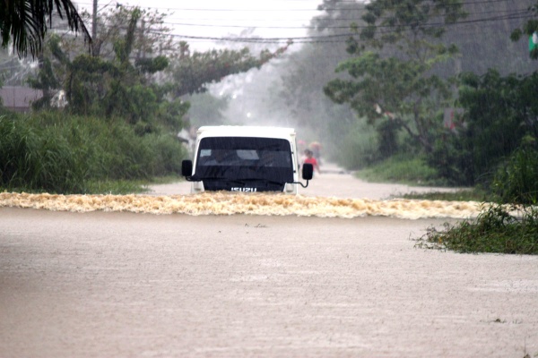 A truck wades through waist deep water in Brgy. Togbongon, Surigao City. Mindanews Photo by Ruel Catoto