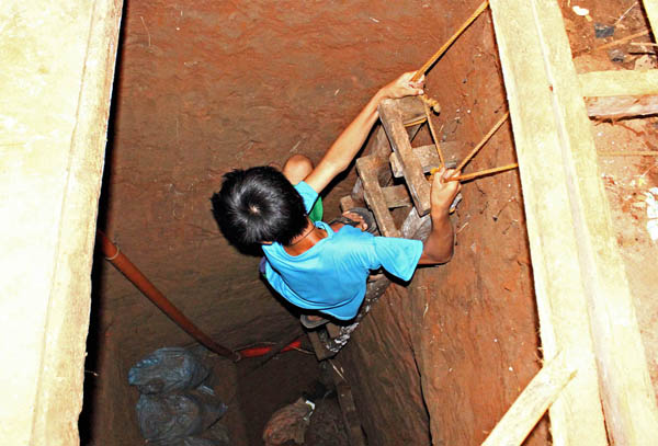 A boy climbs down the 86-meter tunnel that ends up inside the prison compound of the Cagayan de Oro City Jail on November 17, 2011. Officials believed that the tunnel would have been used by inmates to escape from the prison facility. The tunnel was discovered by jail officials last Tuesday, Nov. 15, 2011. MindaNews photo by Erwin Mascarinas