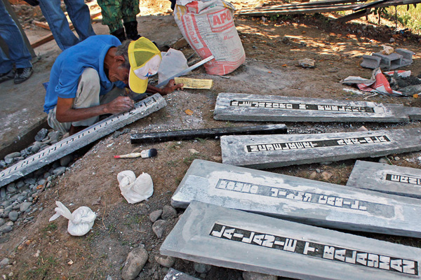 A worker engraves one of the stone markers with the names of the victims of the Ampatuan Massacre in Sitio Masalay, Barangay Salman in Ampatuan town, Maguindanao, on Tuesday, November 22, 2011. Masalay is the same place where the carnage occurred on November 23, 2009. International media organizations have designated the day of the massacre as International Day to End Impunity. MindaNews photo by Erwin Mascarinas