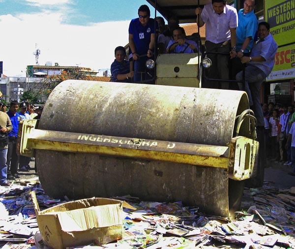 CRUSH! Hundreds of counterfeit DVDs are crushed by a roadroller driven by Mayor Celso Lobregat and other officials in Zamboanga City on Feb. 23, 2012. MindaNews photo