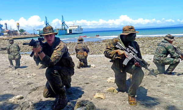 WAR GAMES. US and Filipino Marines crouch in battle positions during a small-boat rescue drill held in Barangay Siguil, Maasim town in Sarangani province on July 4, 2012. The Philippines and the US are leading nine nations participating in the 18th annual Cooperation Afloat Readiness and Training (CARAT) Exercise. MindaNews photo by Bong Sarmiento