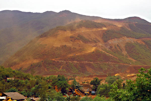 RED MOUNTAIN. Heavy clouds of red dust blanket a mountain as trucks carry ore from the open pit mine in sitio Kinalablaban in Barangay Cagdianao, Claver town in Surigao del Norte. MindaNews File Photo by Erwin Mascarinas