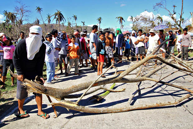 Angry residents block a highway in Barangay San Antonio, Cateel town, Davao Oriental. On Dec. 11. Residents are resorting to blocking the highway to stop relief trucks after they alleged that they were given only one package since typhoon Pablo struck last Dec. 4. Mindanews photo by Erwin Mascarinas