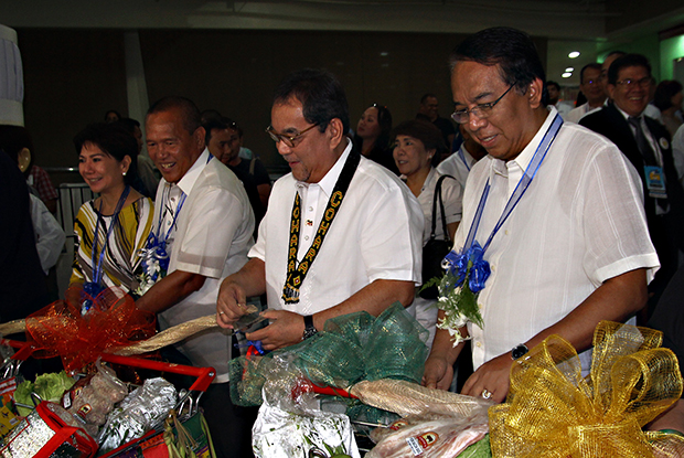 Tourism Secretary Ramon Jimenez Jr. (2nd right) together with Cagayan de Oro Mayor Oscar Moreno, wife Arlene Moreno (far left) and Region 10 tourism director Catalino Chan III (far right) cut the ribbon opening the 17th Kumbira culinary show and live competitions at the Limketkai Mall on August 14, 2013. MindaNews photo by Erwin Mascarinas