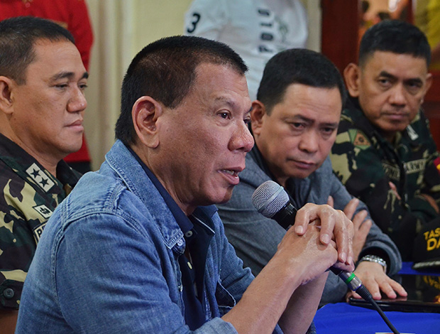 Mayor Rodrigo Duterte, coming straight from a trip in Korea, presides over the security command conference at the Men Seng Hotel Tuesday morning following the twin blasts Monday night inside the movie theaters of two big shopping malls in Davao City. MindaNews photo by Rene Lumawag