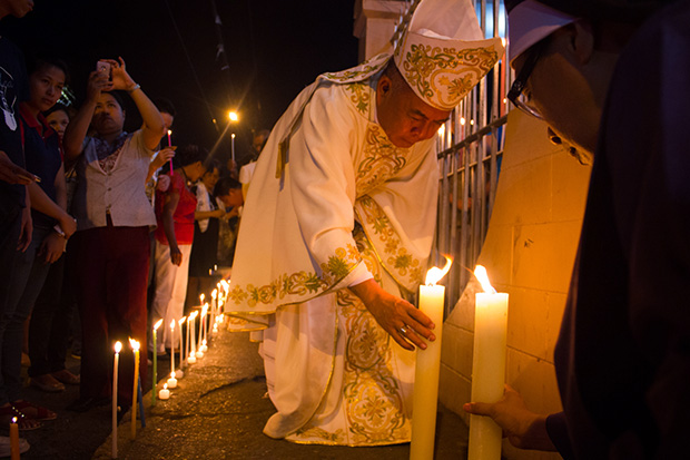 Archbishop Romulo Valles of the Archdiocese of Davao City leads churchgoers for a candle lighting for peace at San Pedro Church on October 1, 2013. Archbishop Valles was archbishop of Zamboanga City prior to his present assignment. .MindaNews photo by Toto Lozano