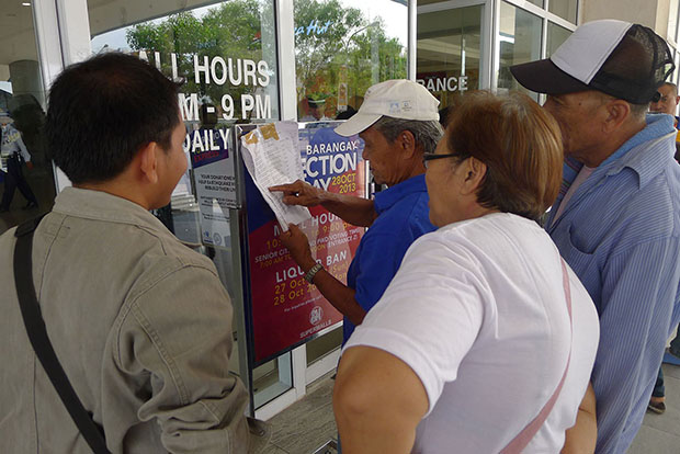 Senior citizens look for their names at the entrance of SM City General Santos during the special voting for senior citizens and persons with disabilities on Monday’s (October 28) barangay polls. (Bong S. Sarmiento/MindaNews)