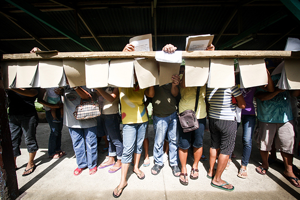 Voters search for their precinct numbers in Sta. Maria, Davao del Sur during the barangay elections on October 28, 2013. The province is also holding a plebiscite for the creation of Davao Occidental province, which covers the towns of Don Marcelino, Jose Abad Santos, Malita, Sta. Maria and Sarangani. MindaNews Photo by Ruby Thursday More