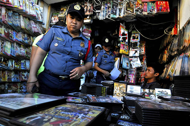 ANTI-PORN DRIVE. Female police officers inspect a retail shop at Cogon Market in Cagayan de Oro City on Tuesday, Jan. 28, for pornographic DVDs. The police and the local government have launched an anti-cyberporn campaign after Cagayan de Oro was tagged as among the top four providers of cyberporn materials to the international market. MindaNews photo by Froilan Gallardo