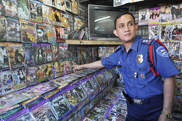ANTI-PORN DRIVE. Supt. Danildo Tumanda of the Cagayan de Oro City Police Office checks a shop for pornographic DVDs in Cogon Market in Cagayan de Oro City on Tuesday Jan. 28. The police and the local government have launched an anti-cyberporn campaign after Cagayan de Oro was tagged as among the top four providers of cyberporn materials to the international market. MindaNews photo by Froilan Gallardo