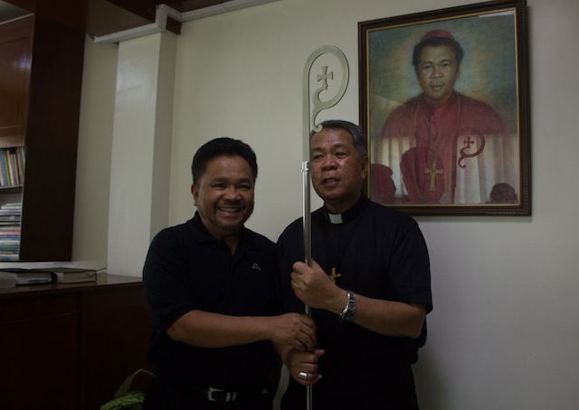 SURPRISE GIFT. Rayland Rogan (left) had no idea tha the pastoral staff he intended to be a surprise gift for Kidapawan Bishop Romulo dela Cruz would be the new staff for the new Archbishop of Zamboanga. MindaNews photo by Toto Lozano 