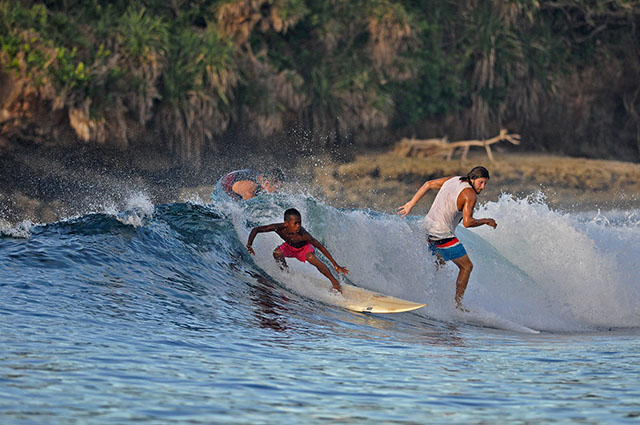 Fourteen-year-old local surfer Toryo Figuron catches a wave better than foreign surfers in Siargao. MindaNews photo courtesy of Skol Moon