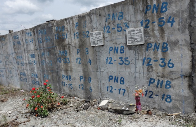 CAN’T WAIT. Relatives of Jun Mark Alcano, 12 and Charlie Traya, 8, no longer waited for the National Bureau of Investigation – Disaster Victim Identification (NBI-DVI) to release the results of the DNA matching. Before November 1, 2013, they claimed a space in the burial vault at the public cemetery in New Bataan, Compostela Valley, and there attached their lapida (grave marker). MindaNews photo by Carolyn O. Arguillas 