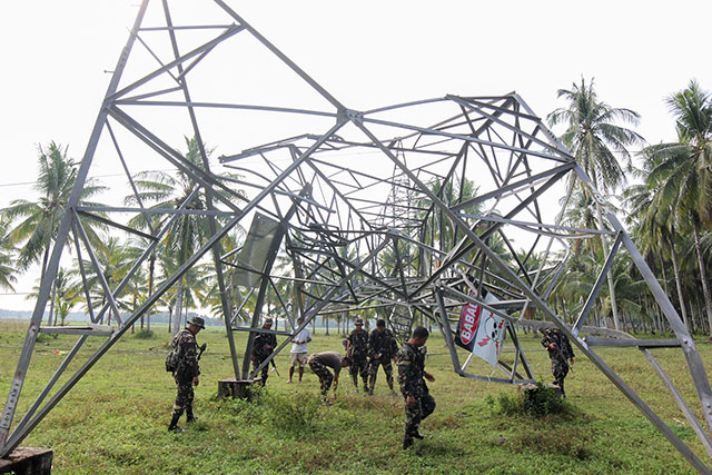 Soldiers check out Tower 26 of the National Grid Corporation of the Philippines (NGCP) transmission line located in Brgy. Galakit, Pagalungan, Maguindanao, which was toppled allegedly by the Bangsamoro Islamic Freedom Fighters (BIFF) Tuesday night (13 Jan 2015), causing blackouts in Maguindanao and North Cotabato. An improvised explosive device (IED) was planted on its steel foundation. Mindanews Photo by Ferdinandh B. Cabrera