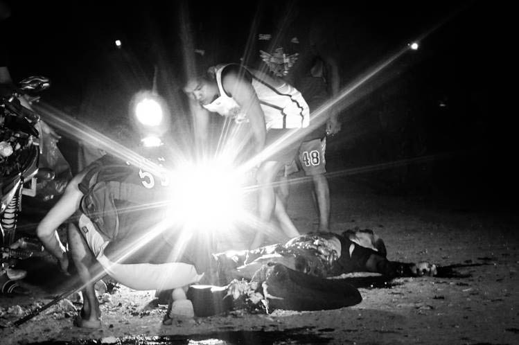 CRIME DOES NOT PAY.  A crowd gathers around the bodies of suspected bombers Tuesday night in Pikit, North Cotabato.  The bomb reportedly exploded while the bomb carriers were on board their motorcycle. POP SALAHOG / MindaNews 