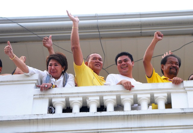 REPRIEVE. Cagayan de Oro Mayor Oscar Moreno (2nd from left) waves to his supporters from the balcony of City Hall after the Court of Appeals issued a “status quo ante” order giving him a 60-day reprieve. With Moreno are his wife, Aileen (left); running mate Rainer Joaquin Uy (in white tshirt); and Misamis Oriental Rep. Pedro Unabia (in yellow tshirt). MindaNews photo by Froilan Gallardo