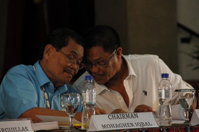 MILF peace panel chair Mohagher Iqbal and Dr. Crispino Saclauso of UP Visayas share some thoughts during the media roundtable discussion on the Bangsamoro Basic Law in Iloilo City on Friday (Dec. 4, 2015). MindaNews photo by H. Marcos C. Mordeno