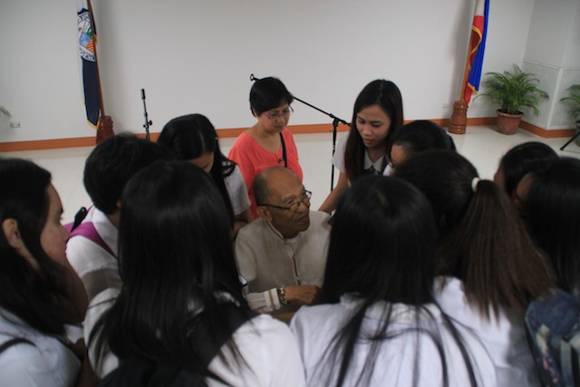 Redemptorist Brother Karl Gaspar, CSsR, is surrounded by students as he autographs their copies of the two books he launched Friday at the Ateneo de Davao University. MindaNews photo by Gregorio Bueno 