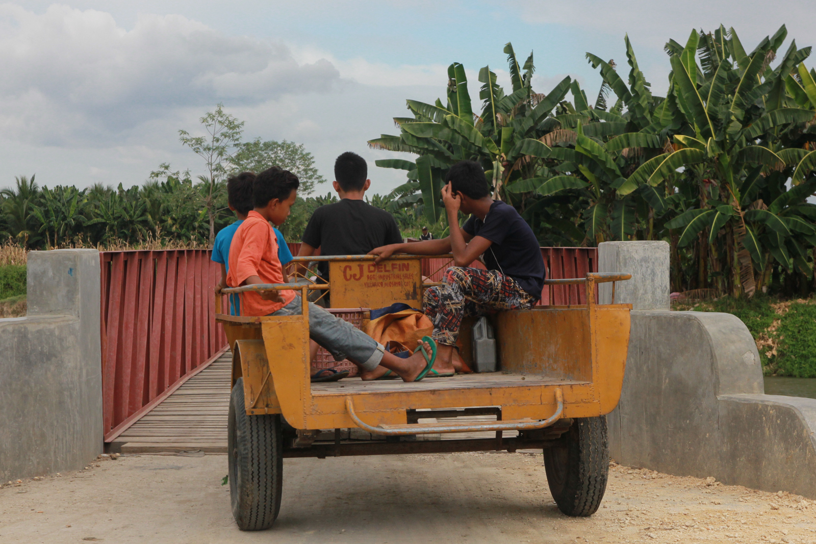 Zaharimin Amilil and his friends ride a hand tractor as they cross a newly-constructed bridge in Barangay Tukanalipao, Mamasapano, Maguindanao on January 19, 2016. They are going to harvest their crops that were attacked by rats in the same area where alll but one of 36 members of the 55th Special Action Company of hte Special Action Force (SAF) were killed on January 25, 2016. Eight other SAF members were killed along wiht 17 members of the MILF's Bangsamoro Islamic Armed Forces and five civilians. MindaNews photo by Toto Lozano 