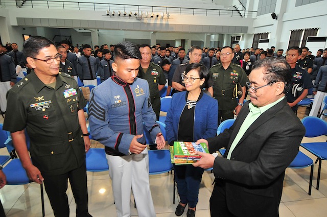 Government and MILF peace panel chairs Miriam Coronel-Ferrer and Mohagher Iqbal hand over some books on the Bangsamoro and the Bangsamoro peace process to Philippine Military Academy (PMA) Superintendent Maj. Gen. Donato San Juan III and this year’s top PMA graduate, Kristian Daeve Gelacio Abiqi during a forum on the Bangsamoro peace process on March 9, 2016 at the PMA in Baguio City. MindaNews photo by FROILAN GALLARDO