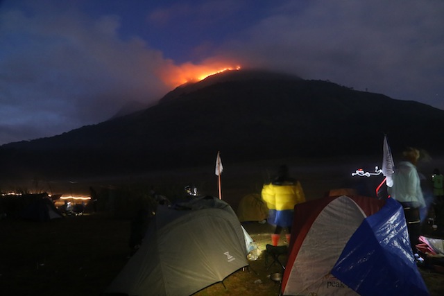 A group of mountaineers and bikers from Cotabato City watched the fire at the peak of Mt. Apo in this photo taken at 4:59 p.m. on Saturday (26 March 2016), as they set up tent in the camping site beside Lake Venado. The Cotabato group claimed three unidentified mountaineers who slept at the peak and cooked there may have caused the fire. Photo courtesy of TUTIN SAPTO / Cotabato All-Terrain Bikers Association (CATBA) 