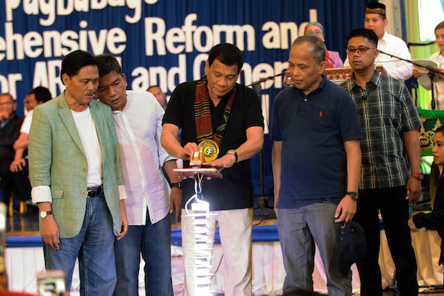 President Rodrigo Duterte prepares for the ceremonial switch-on of the household electrification program by the Department of Energy and National Electrification Agency during the launch of the Comprehensive Reform and Development Agenda for Autonomous Region in Muslim Mindanao (ARMM) and other Conflict-Affected Areas in Regions 9, 10, and 12 at Shariff Kabunsuan Cultural Complex in Cotabato City on October 29. With the President are Technical Education and Skills Development Authority (TESDA) Director-General Guiling Mamondiong, ARMM Governor Mujiv Hataman, and Energy Secretary Alfonso Cusi. ACE MORANDANTE/Presidential Photos 