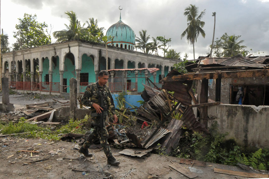 A soldiers walks past a bombed-out mosque in Butig, Lanao del Sur after government troops retook Butig town from the Maute group. MindaNews photo by Froilan Gallardo