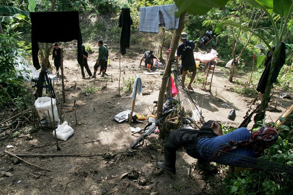 NO WAR TODAY New Peoples Army (NPA) rebels appear relaxed as they grill meat and take a rest inside their temporary guerrilla base in the hinterlands of Paquibato District, Davao City. MindaNews Photo by Keith Bacongco